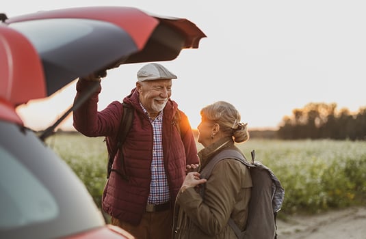 Man and Woman standing by car