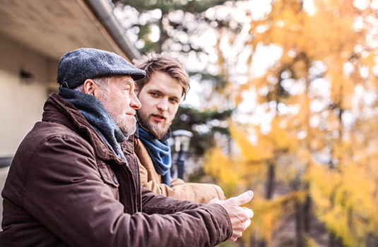 Two men outside talking